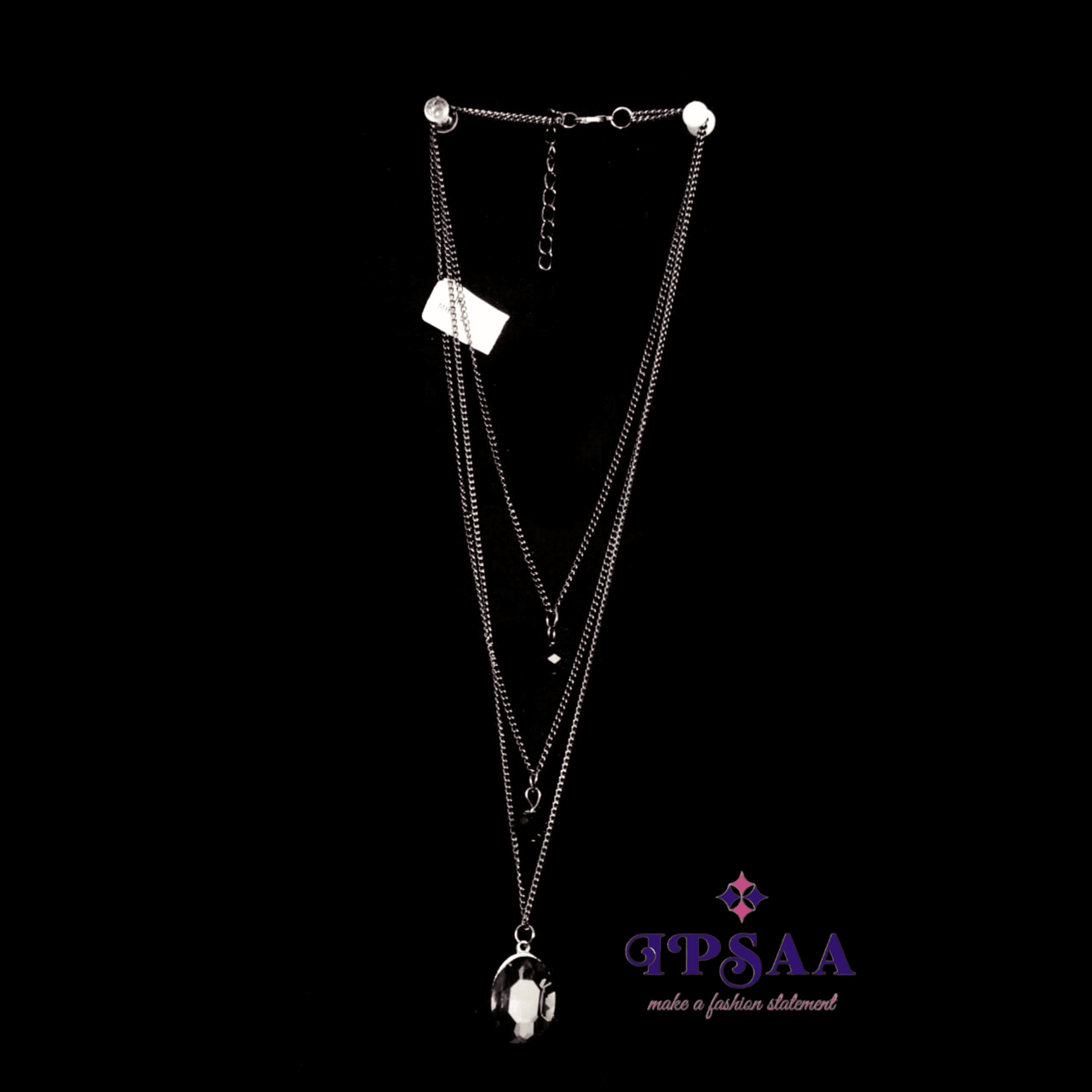 Multi layered necklace with black stud in center.